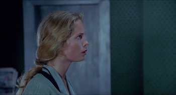 Movie still from “Insomnia” (1997), directed by Erik Skjoldbjærg – A woman with blonde hair looking to the side; Close Up shot, Over the shoulder angle