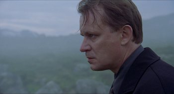 Movie still from “Insomnia” (1997), directed by Erik Skjoldbjærg – A person looking at the camera; Close Up shot, Low angle