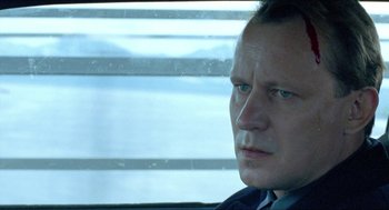 Movie still from “Insomnia” (1997), directed by Erik Skjoldbjærg – A person looking out a window; Close Up shot, Low angle