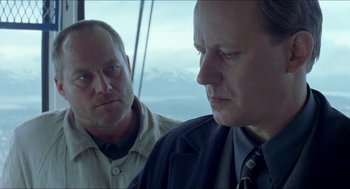 Movie still from “Insomnia” (1997), directed by Erik Skjoldbjærg – Two men are looking at one another in a window; Close Up shot, Low angle