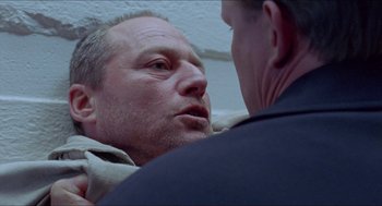 Movie still from “Insomnia” (1997), directed by Erik Skjoldbjærg – Two men are facing each other in a room; Close Up shot, Low angle