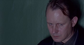 Movie still from “Insomnia” (1997), directed by Erik Skjoldbjærg – A person looking down; Close Up shot, Over the shoulder angle