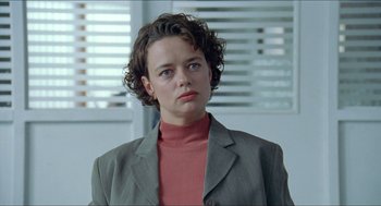 Movie still from “Insomnia” (1997), directed by Erik Skjoldbjærg – A woman in a jacket and a red shirt; Close Up shot, Over the shoulder angle