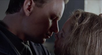 Movie still from “Insomnia” (1997), directed by Erik Skjoldbjærg – A man and a woman face to face in a dark room; Close Up shot, Low angle