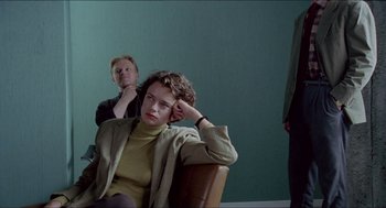 Movie still from “Insomnia” (1997), directed by Erik Skjoldbjærg – A woman sitting in a chair next to another woman; Medium shot, Over the shoulder angle