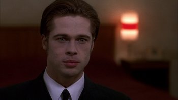 Movie still from “Interview with the Vampire: The Vampire Chronicles” (1994), directed by Neil Jordan – A man in a suit and tie looking at the camera; Close Up shot, Over the shoulder angle