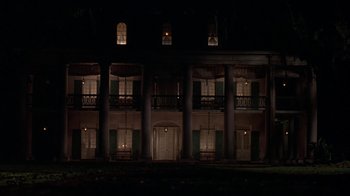 Movie still from “Interview with the Vampire: The Vampire Chronicles” (1994), directed by Neil Jordan – A large building lit up at night with windows; Extreme Wide shot, Low angle