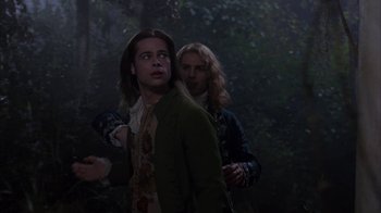 Movie still from “Interview with the Vampire: The Vampire Chronicles” (1994), directed by Neil Jordan – Two people in a forest , one of whom is holding a knife in his hand; Medium shot, Over the shoulder angle
