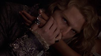 Movie still from “Interview with the Vampire: The Vampire Chronicles” (1994), directed by Neil Jordan – A woman with a ring on her finger is holding her hand up to her face; Close Up shot, Over the shoulder angle