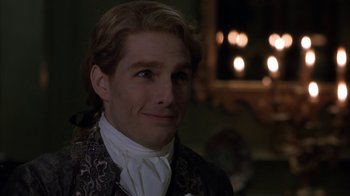 Movie still from “Interview with the Vampire: The Vampire Chronicles” (1994), directed by Neil Jordan – A person wearing a suit and tie; Close Up shot, Over the shoulder angle