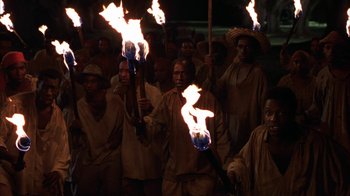 Movie still from “Interview with the Vampire: The Vampire Chronicles” (1994), directed by Neil Jordan – A group of people holding torches in a crowd; Wide shot, High angle