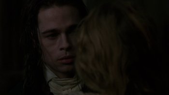 Movie still from “Interview with the Vampire: The Vampire Chronicles” (1994), directed by Neil Jordan – A person in a suit looking at the camera; Close Up shot, Over the shoulder angle