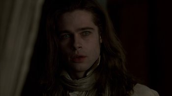Movie still from “Interview with the Vampire: The Vampire Chronicles” (1994), directed by Neil Jordan – A man with long brown hair and green eyes stares straight ahead; Close Up shot, Over the shoulder angle