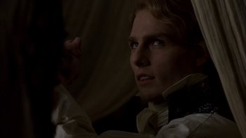 Movie still from “Interview with the Vampire: The Vampire Chronicles” (1994), directed by Neil Jordan – A man in a white shirt is looking at the camera; Close Up shot, Over the shoulder angle
