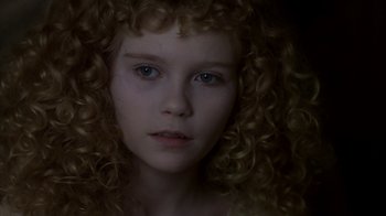 Movie still from “Interview with the Vampire: The Vampire Chronicles” (1994), directed by Neil Jordan – A person with curly hair; Close Up shot, High angle