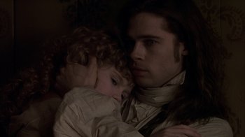 Movie still from “Interview with the Vampire: The Vampire Chronicles” (1994), directed by Neil Jordan – A man holding a young girl in his arms; Close Up shot, Low angle