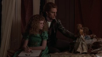 Movie still from “Interview with the Vampire: The Vampire Chronicles” (1994), directed by Neil Jordan – A man and a woman sitting next to each other at a table; Medium shot, Over the shoulder angle