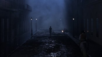 Movie still from “Interview with the Vampire: The Vampire Chronicles” (1994), directed by Neil Jordan – A person walking down a street in the fog; Extreme Wide shot, High angle