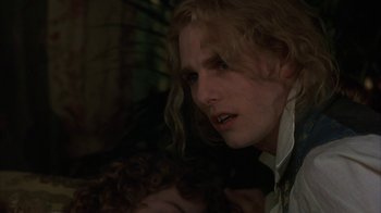 Movie still from “Interview with the Vampire: The Vampire Chronicles” (1994), directed by Neil Jordan – A person with long curly hair; Close Up shot, Over the shoulder angle
