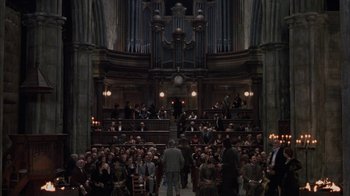 Movie still from “Interview with the Vampire: The Vampire Chronicles” (1994), directed by Neil Jordan – A crowd of people sitting in a large room; Extreme Wide shot, High angle