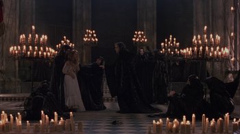 Movie still from “Interview with the Vampire: The Vampire Chronicles” (1994), directed by Neil Jordan – A group of people dressed up in black robes; Wide shot, High angle
