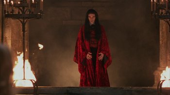 Movie still from “Interview with the Vampire: The Vampire Chronicles” (1994), directed by Neil Jordan – A woman in a long red robe standing on a stage; Medium shot, Low angle