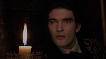 Movie still from “Interview with the Vampire: The Vampire Chronicles” (1994), directed by Neil Jordan – A man with a candle in a dark room; Close Up shot, Over the shoulder angle