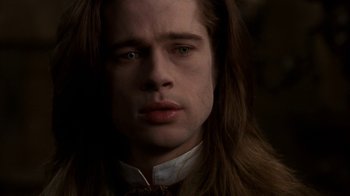 Movie still from “Interview with the Vampire: The Vampire Chronicles” (1994), directed by Neil Jordan – A person with long brown hair; Close Up shot, Low angle
