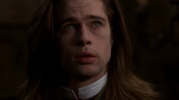 Movie still from “Interview with the Vampire: The Vampire Chronicles” (1994), directed by Neil Jordan – A person with long brown hair; Close Up shot, Low angle