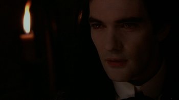 Movie still from “Interview with the Vampire: The Vampire Chronicles” (1994), directed by Neil Jordan – A person wearing a suit and tie; Close Up shot, Over the shoulder angle