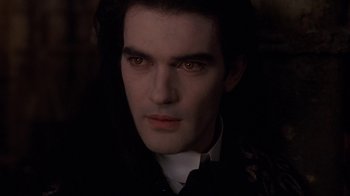 Movie still from “Interview with the Vampire: The Vampire Chronicles” (1994), directed by Neil Jordan – A person wearing a suit and tie; Close Up shot, High angle