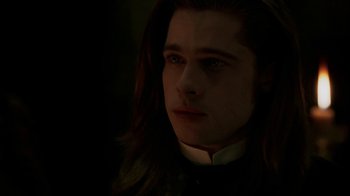 Movie still from “Interview with the Vampire: The Vampire Chronicles” (1994), directed by Neil Jordan – A man with long dark hair wearing a priest's collar; Close Up shot, Over the shoulder angle