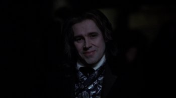 Movie still from “Interview with the Vampire: The Vampire Chronicles” (1994), directed by Neil Jordan – A person wearing a suit and tie; Close Up shot, Over the shoulder angle