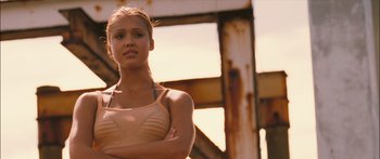 Movie still from “Into the Blue” (2005), directed by John Stockwell – A beautiful young woman standing next to a metal structure; Close Up shot, Low angle