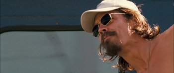 Movie still from “Into the Blue” (2005), directed by John Stockwell – A person wearing a hat and sunglasses; Close Up shot, Low angle
