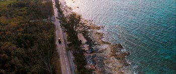 Movie still from “Into the Blue” (2005), directed by John Stockwell – An aerial view of a road near the ocean; Extreme Wide shot, High angle