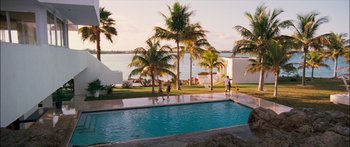 Movie still from “Into the Blue” (2005), directed by John Stockwell – A group of people standing next to a swimming pool; Extreme Wide shot, High angle