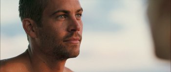 Movie still from “Into the Blue” (2005), directed by John Stockwell – A man's face in the sunlight; Close Up shot, Over the shoulder angle