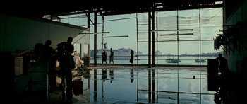 Movie still from “Into the Blue” (2005), directed by John Stockwell – A group of people standing in front of a large window; Extreme Wide shot, Low angle