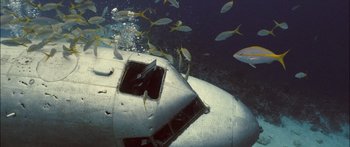 Movie still from “Into the Blue” (2005), directed by John Stockwell – An underwater view of an airplane with fish swimming around it; Extreme Wide shot, Overhead angle