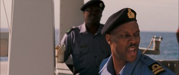 Movie still from “Into the Blue” (2005), directed by John Stockwell – A man in a uniform and a man in a hat; Close Up shot, Low angle
