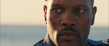 Movie still from “Into the Blue” (2005), directed by John Stockwell – A man's face with the ocean in the background; Extreme Close Up shot, Over the shoulder angle