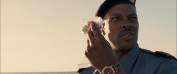 Movie still from “Into the Blue” (2005), directed by John Stockwell – A person holding a piece of food; Close Up shot, Low angle