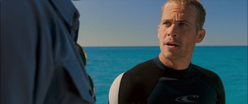 Movie still from “Into the Blue” (2005), directed by John Stockwell – A man in a wetsuit talking to another man in a wetsuit; Close Up shot, Over the shoulder angle