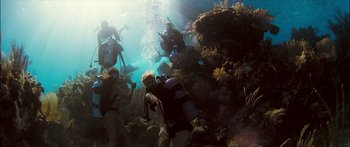 Movie still from “Into the Blue” (2005), directed by John Stockwell – A group of people scuba diving in the ocean; Wide shot, High angle