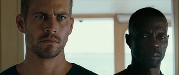 Movie still from “Into the Blue” (2005), directed by John Stockwell – A person holding a camera; Close Up shot, Over the shoulder angle