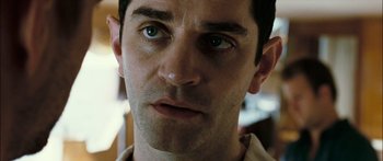 Movie still from “Into the Blue” (2005), directed by John Stockwell – A man's face with green eyes; Close Up shot, Low angle