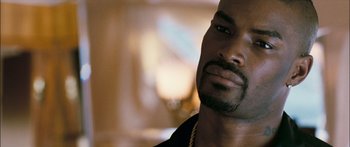 Movie still from “Into the Blue” (2005), directed by John Stockwell – A person wearing a necklace; Close Up shot, Over the shoulder angle