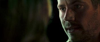 Movie still from “Into the Blue” (2005), directed by John Stockwell – A man's face in the dark; Extreme Close Up shot, Over the shoulder angle