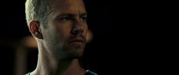 Movie still from “Into the Blue” (2005), directed by John Stockwell – A man's face in the dark; Close Up shot, Over the shoulder angle